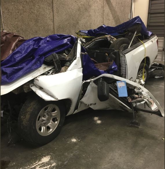 A white pick up truck crumpled from a fatal DUI car accident