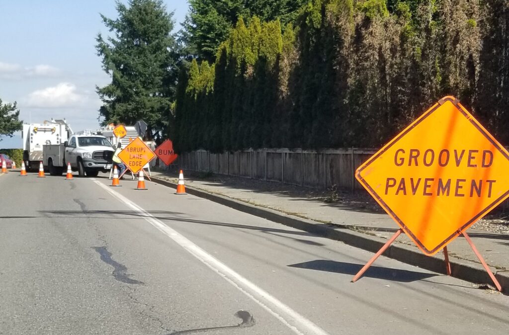 grooved pavement, road work sign, road w