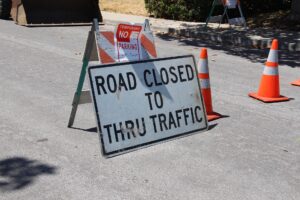 a construction sign reads "road closed to thru traffic"