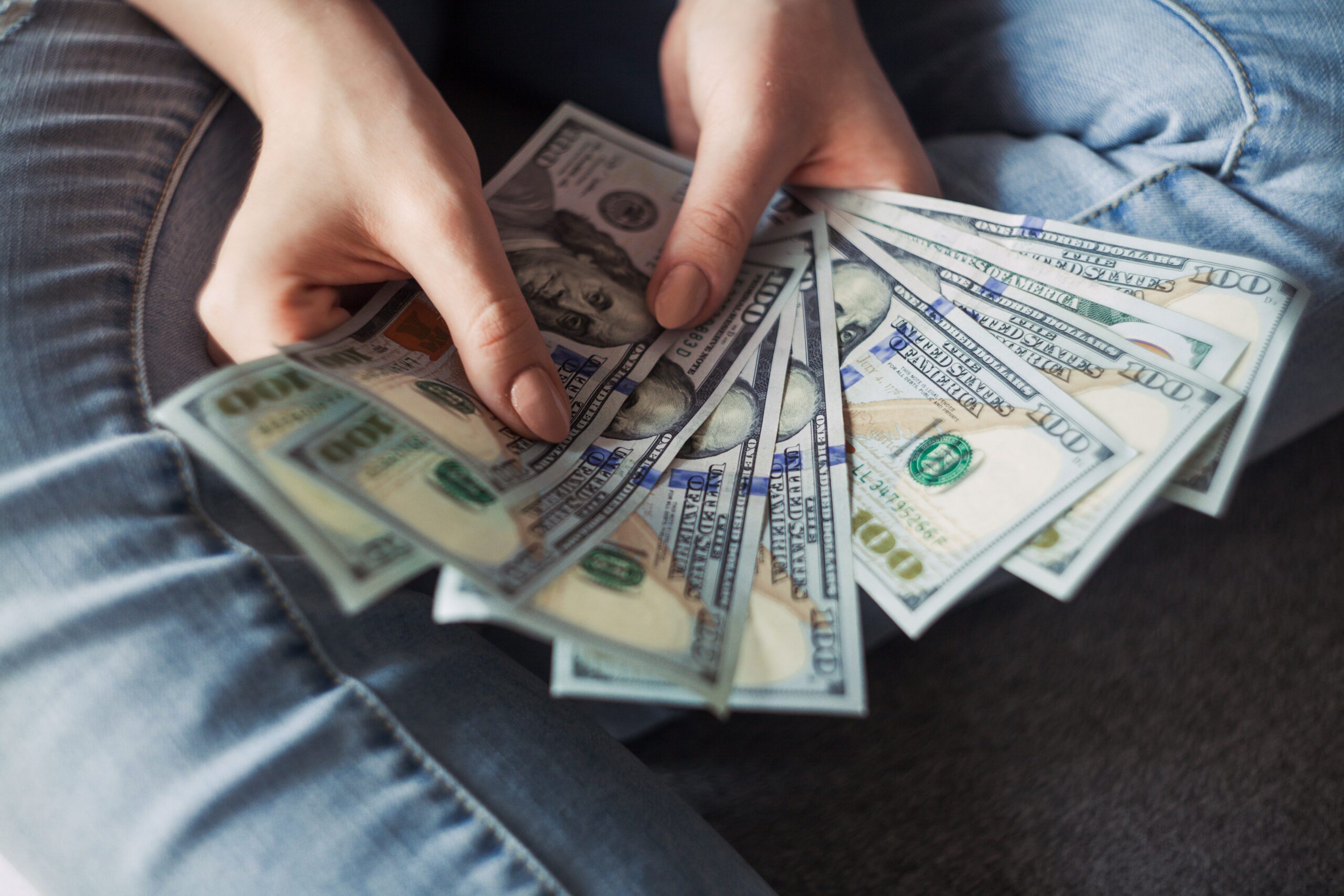year-end bonus, how to spend year-end bonus, money, hand full of money
