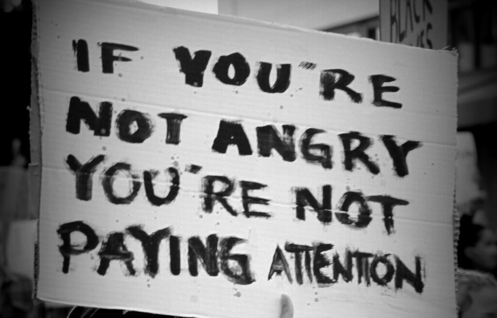 A protester holds a sign during the June 2 BLM protest | photo by Amy Thompson