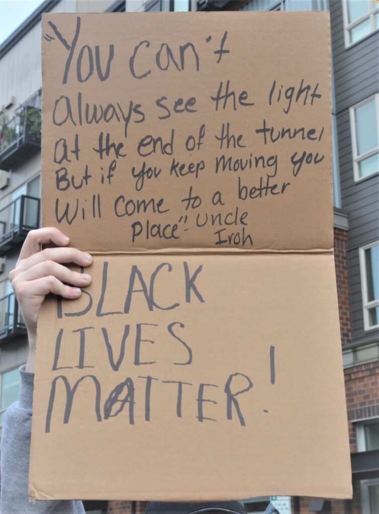 A protester holds a sign during the June 2 BLM protest | photo by Amy Thompson