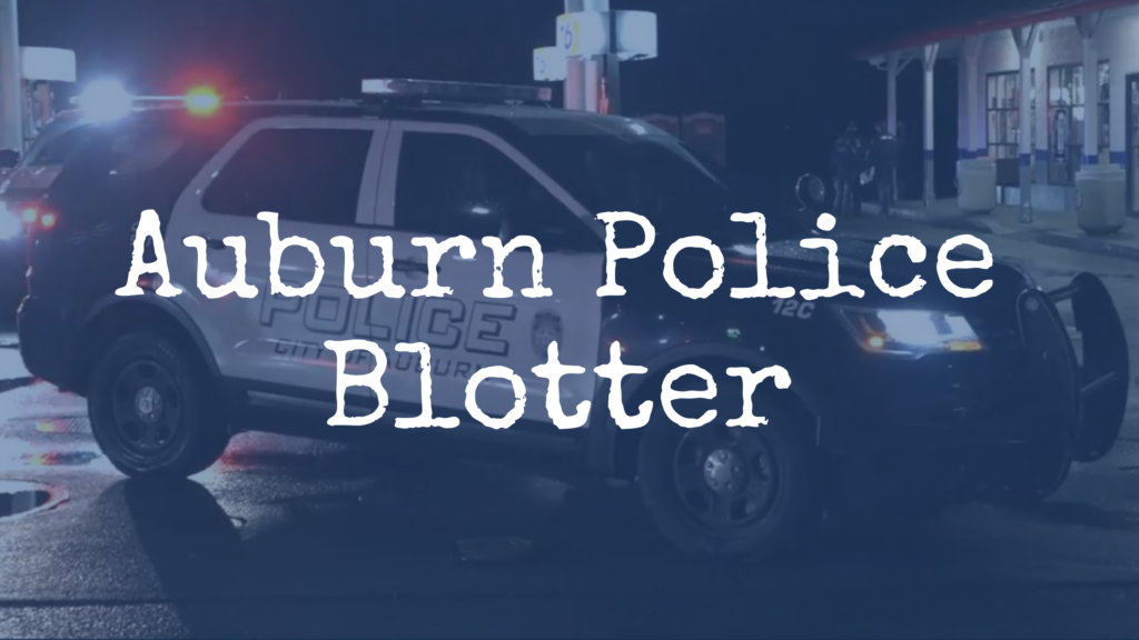 a photo of an APD SUV at night at a crime scene at a gas station "Auburn Police Blotter" is written over the photo