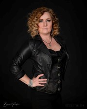 Female singer song writer Jessica Lynne Witty stands with her hand on her hip looking toward the camera
