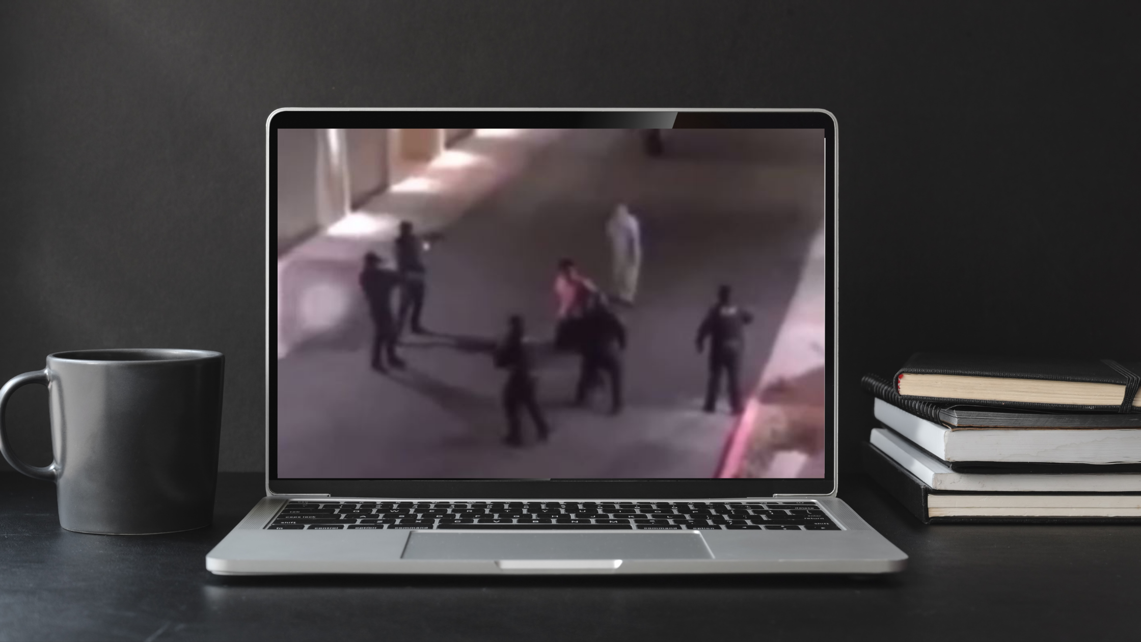 A screengrab of the video is on a laptop on a desk
