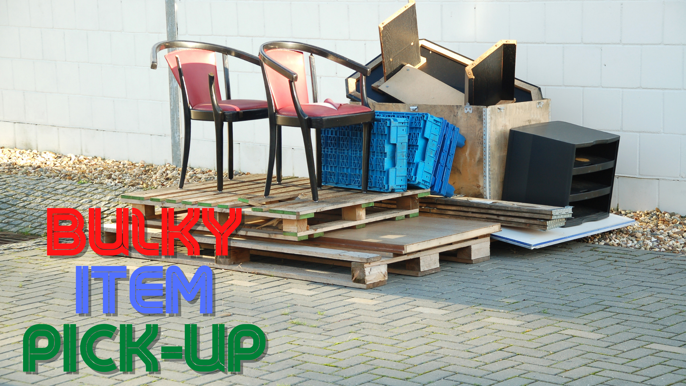 items stacked against a wall and on pallets, waiting to be picked up. the words "Bulky Item Pick-up" are in the lower left corner