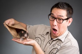 Entertainer Louie Foxx looks surprised as a mouse crawls from a bag onto his hand