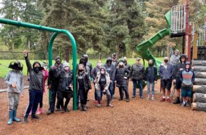 A team of Avery Huffman DIPG Foundation volunteers pose on a playground after working during Auburn's clean sweep 2021