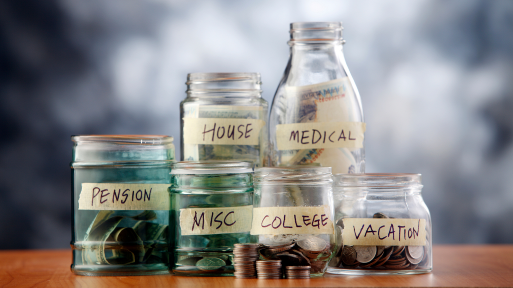 Jars with money in them are labeled with things like Health, Investments, Education