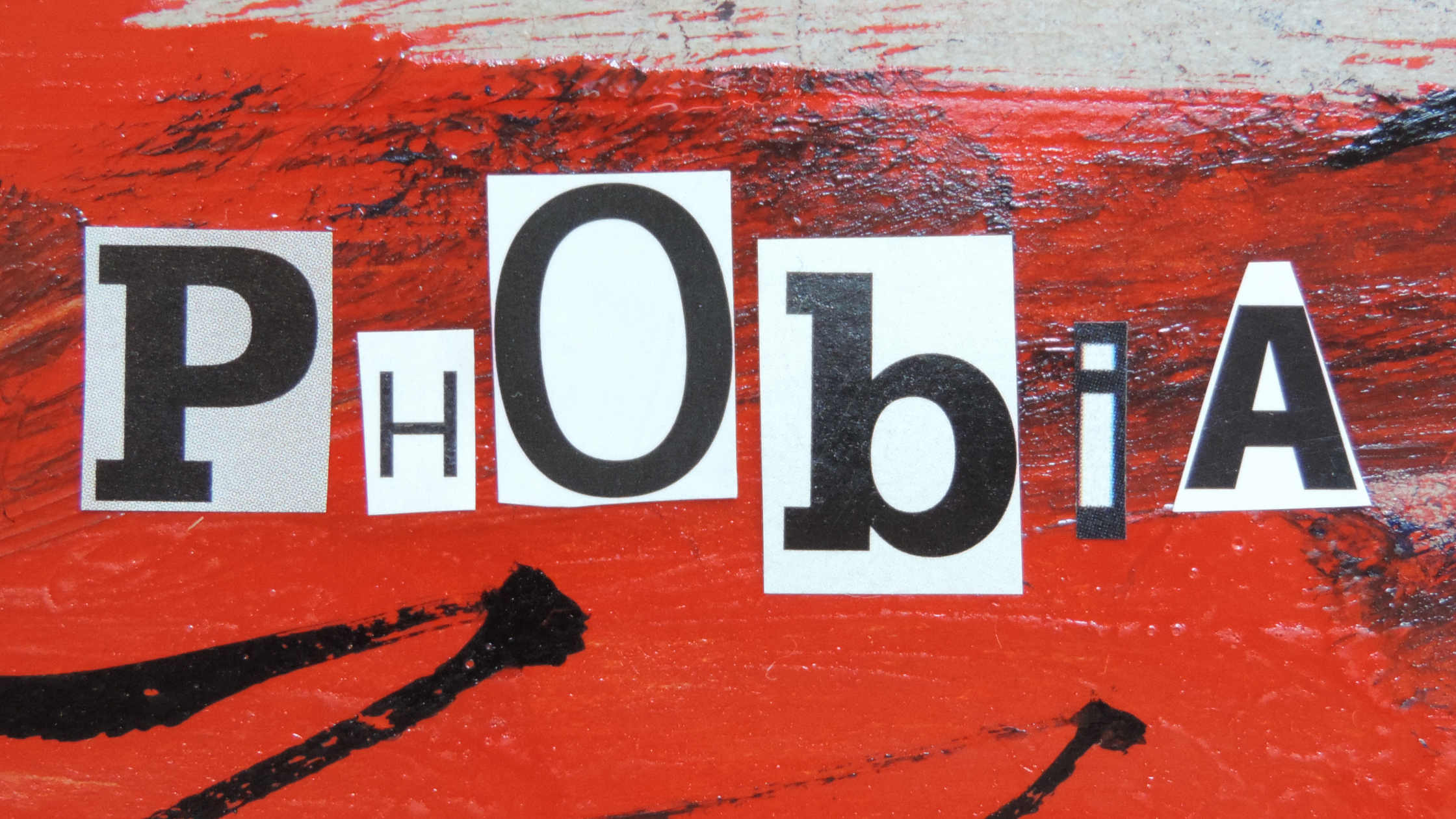 Graphic with a red and black background and the word phobia spelled out in separated letters of differing sizes