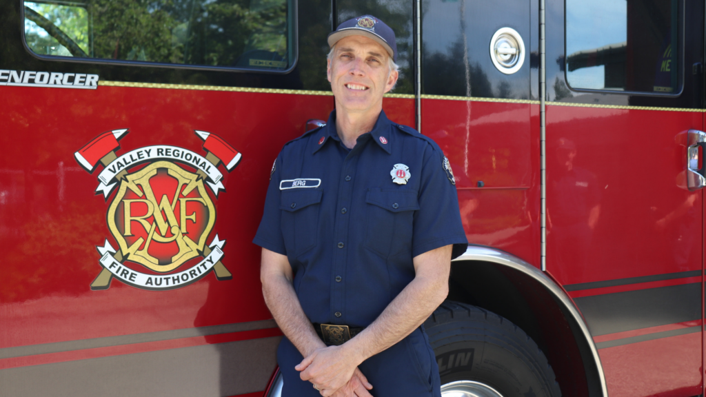 Vrfa captaon Dave Berg next to a of a fire truck