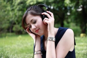 a female listens to music outside