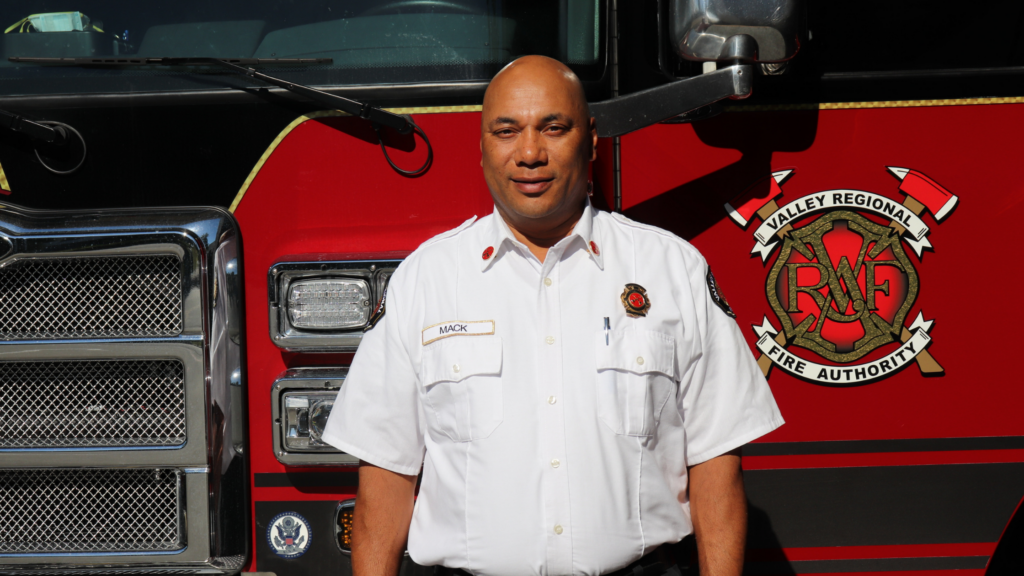 VRFA Battalion Chief Bill Back in front of a VRFA Fire Engine