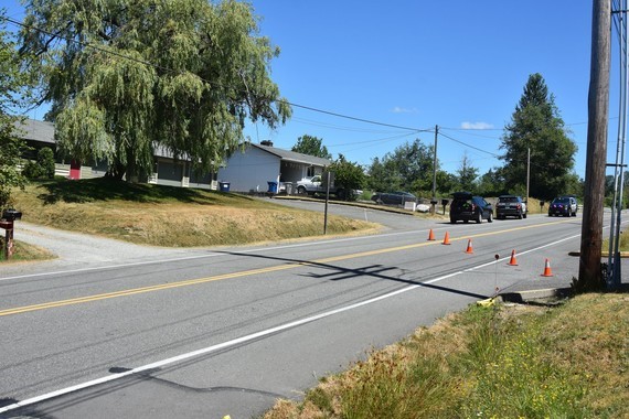 Cones block a residential street, KCSO SUVs parked beyond the cones