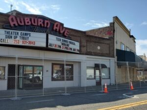 The from of the Auburn Avenue Theater with a temporary chain link fence around it due to the recent MAx House Fire