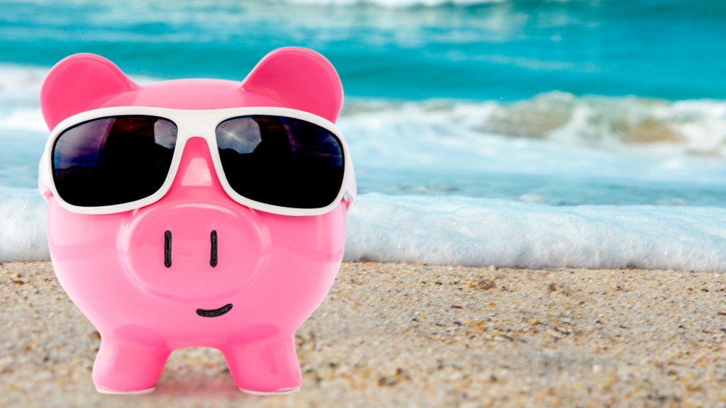 a piggy bank wear sunglasses while on a beach