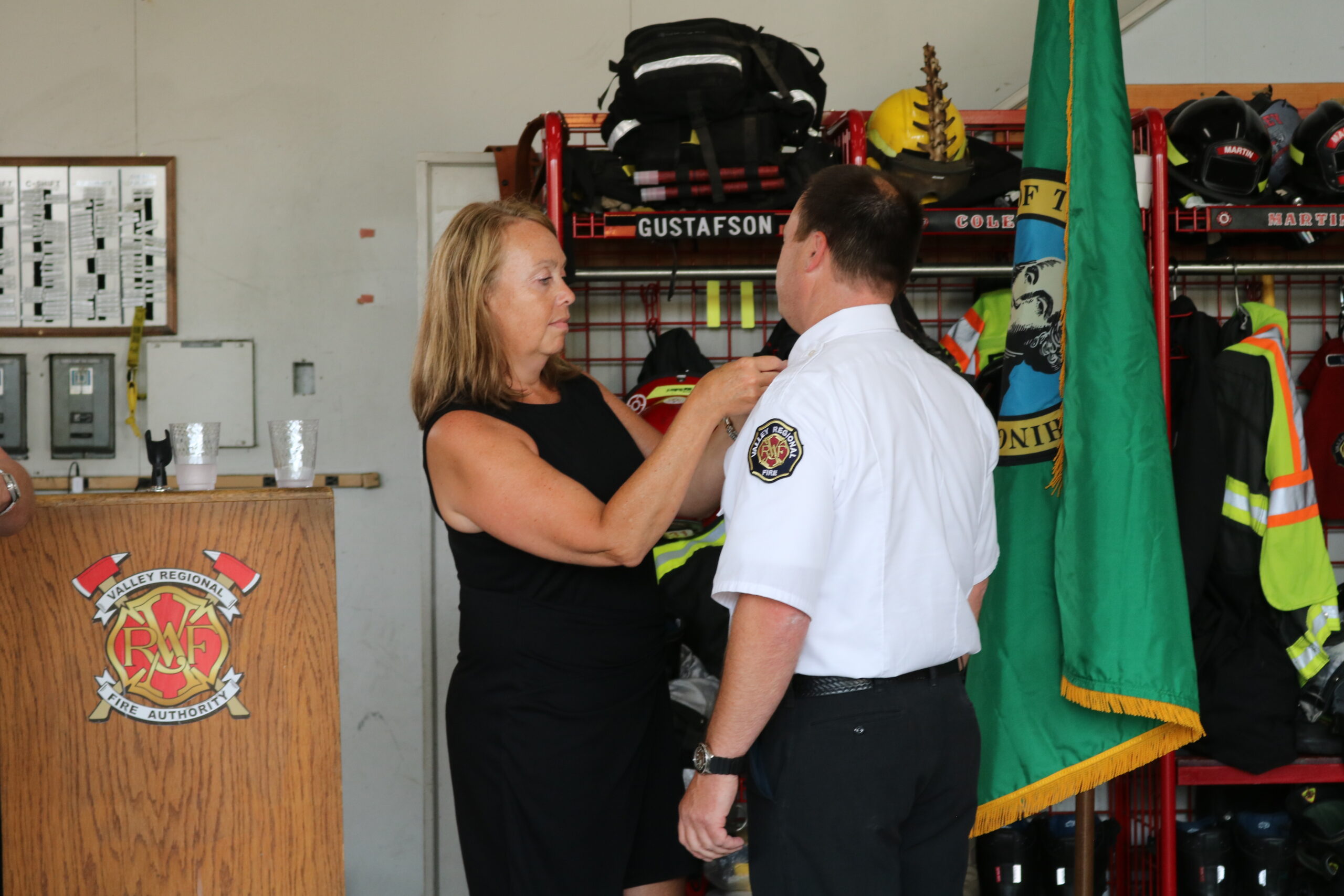 VRFA Chief Brad Thompson receives his Chief's pin, placed on his lapel by his wife.