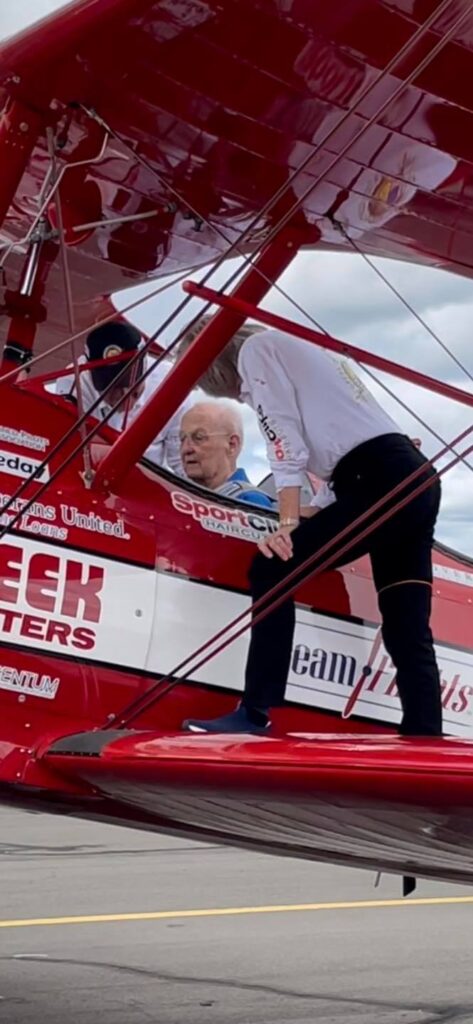 Prestige living resident Roy Climber in a restored biplane