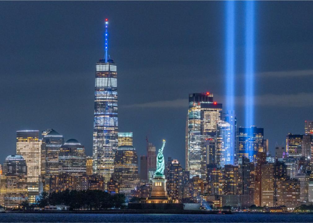 a photo of two memorial lights shining in the NYC skyline in place of the twin towers