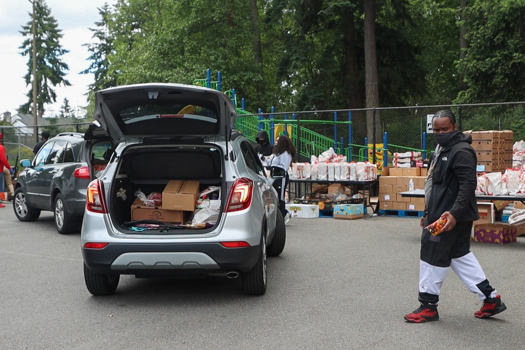 Cars line up to receive food boxes