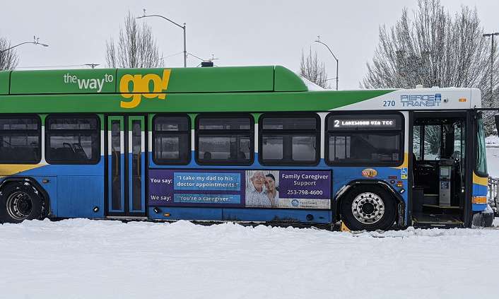 A pierce County Transit Bus waits for passengers along a snowbank