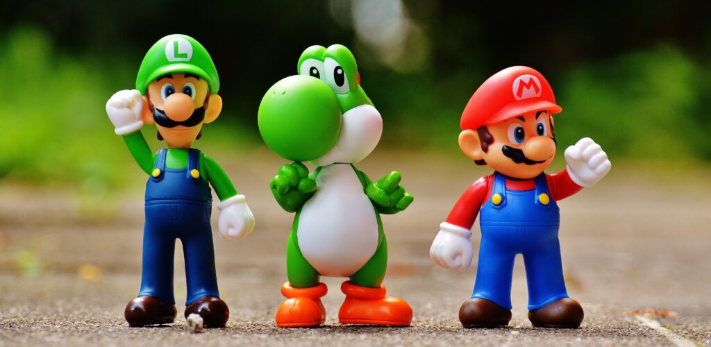 Photo of Super Mario, Luigi, and Yoshi Figurines in a row