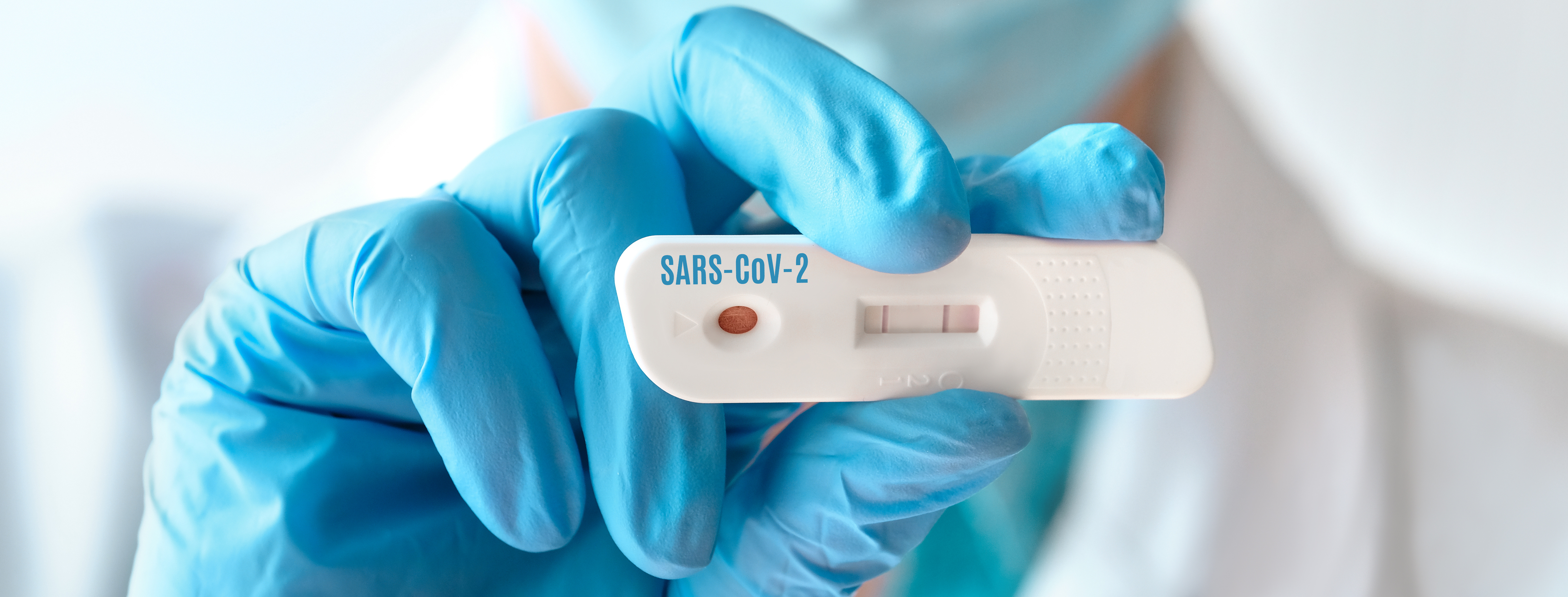 Doctor shows rapid laboratory COVID-19 test for detection of IgM and IgG antibodies to Novel Coronavirus, SARS-CoV-2 with positive result. Immunity against Covid-19, panoramic banner image.
