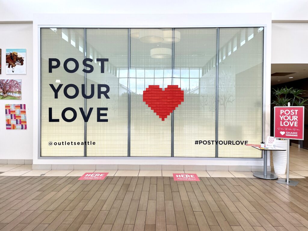 the Post Your Love wall at The Outlet Collection