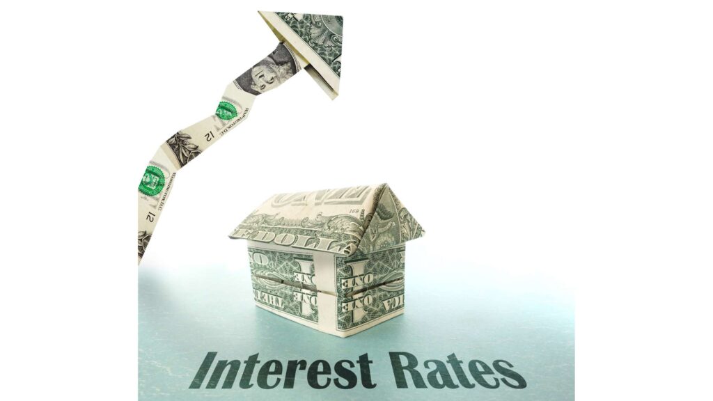 a house made of dollar bills sits under a jagged arrow, also made of money, rising above it