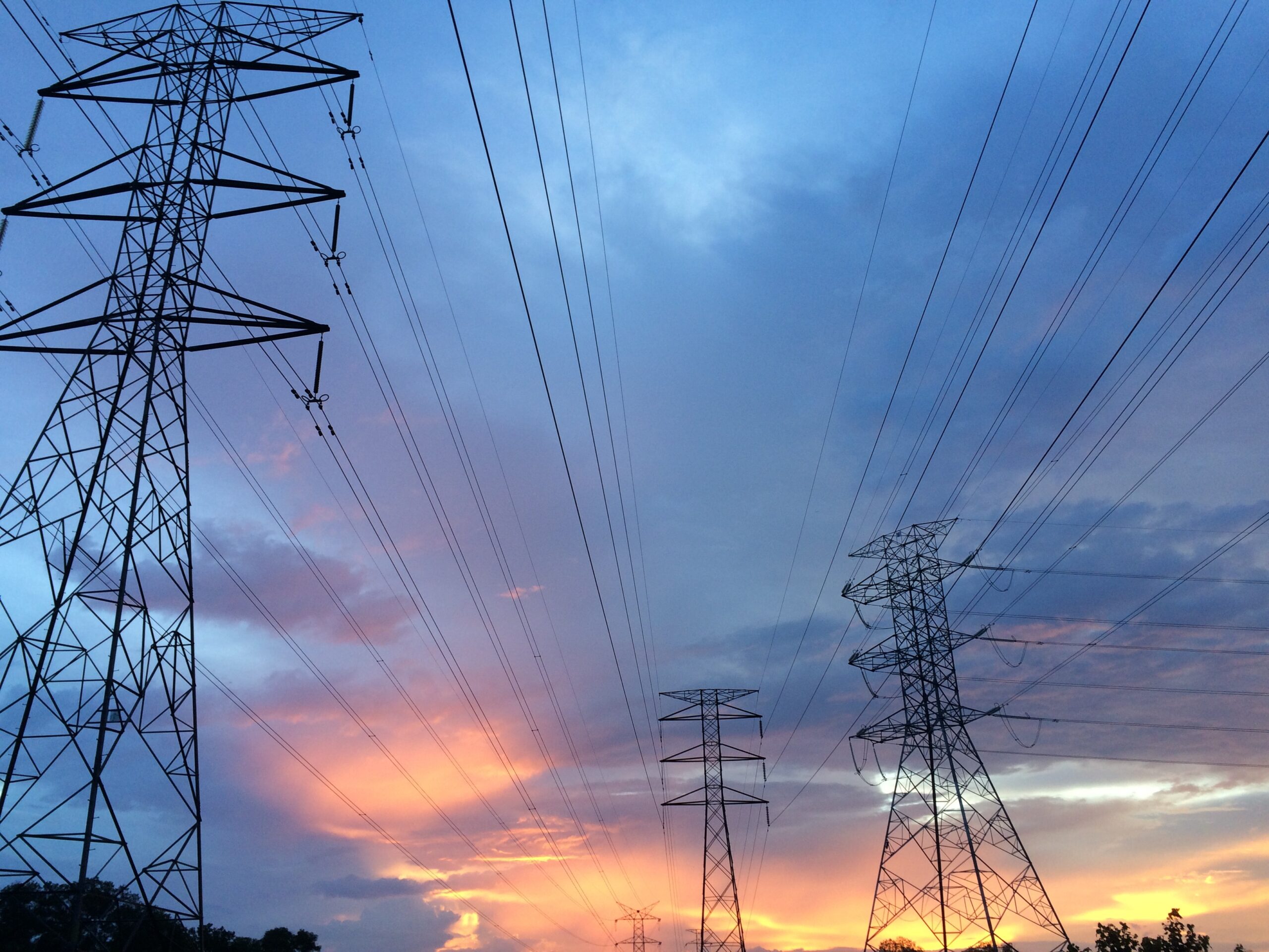 Electric power lines with a vibrant sunset
