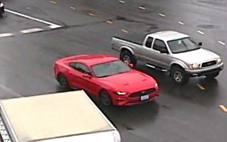 Still captured from footage of a ford mustang driving next to a silver truck