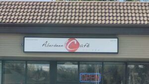 An overhead storefront sign for Aberdeen Cafe