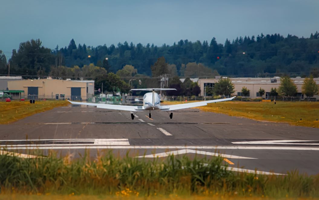 A private airplane takes off on a smaller runway
