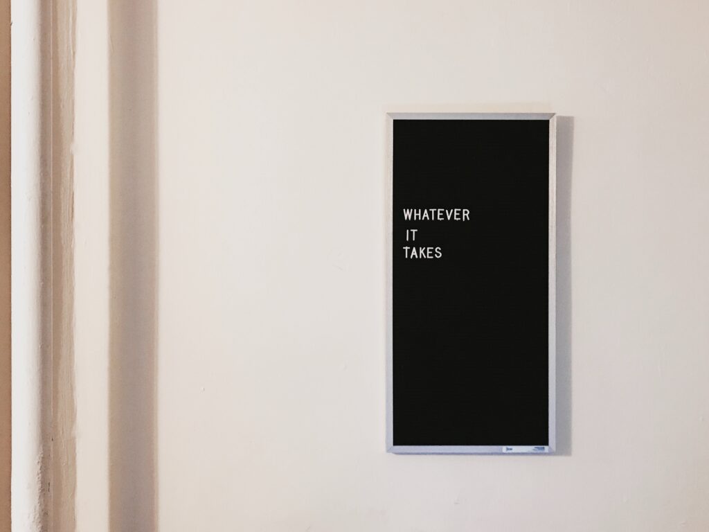 a sign hangs on the wall reading "whatever it takes"