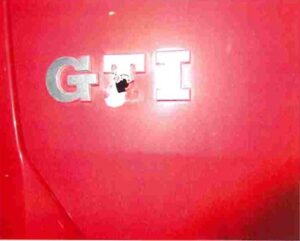 A bullet hole through a red GTI