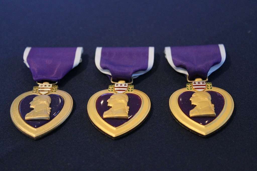 three purple heart medals in a row