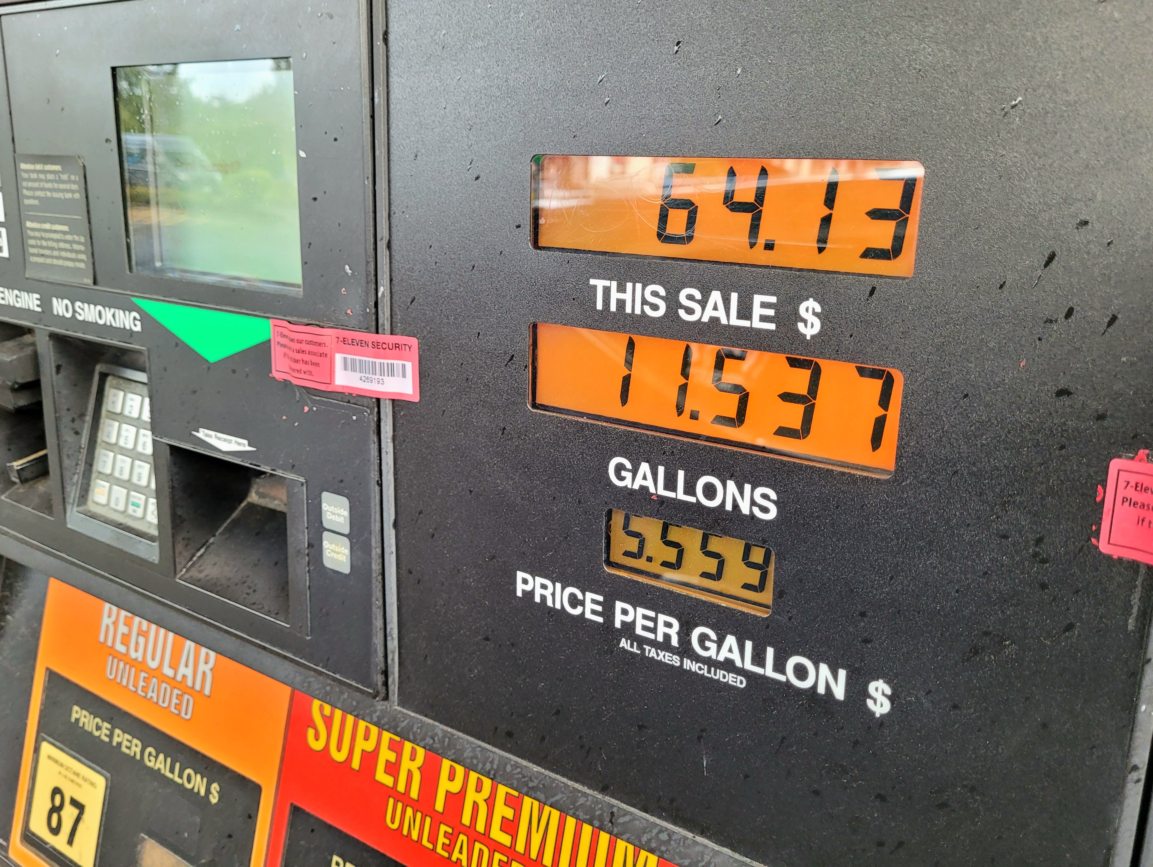 The digital read out panel on a gas pump, reflecting a $64.13 sale for 11.537 gallons at 55.59 per gallon