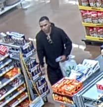 a still frame from security footage of a light skinned male POC in a grocery store.