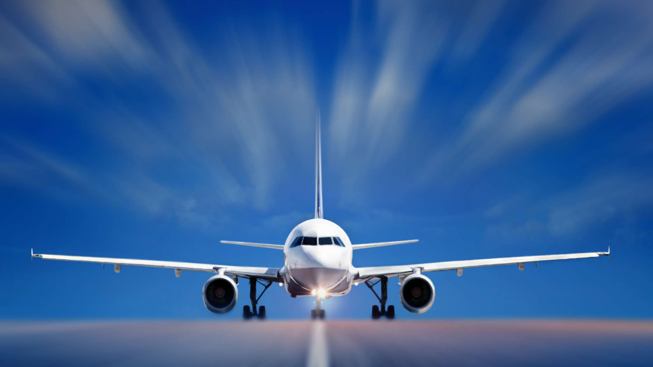 A plane taxis on a runway toward the camera