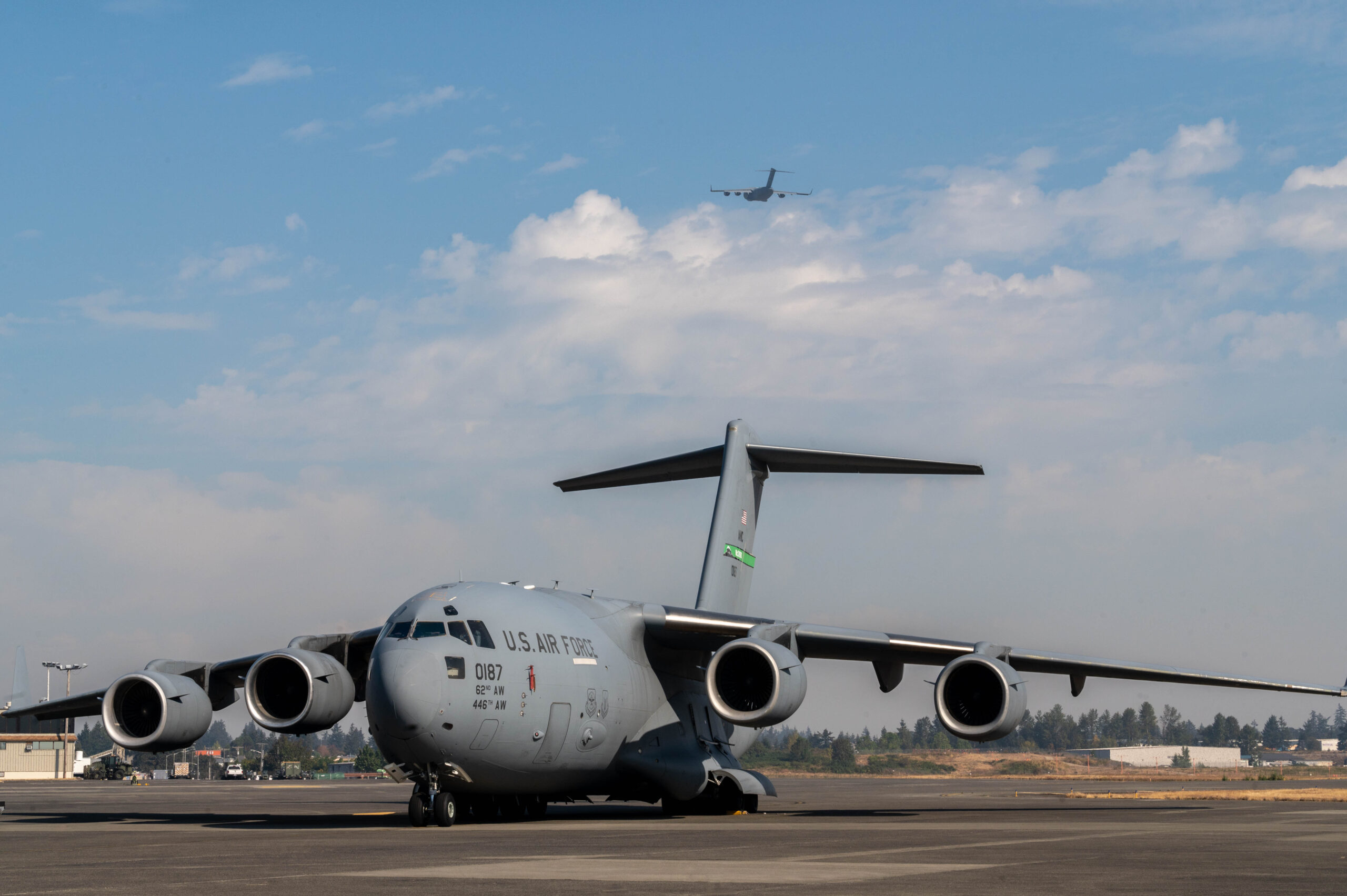 A U.S. Air Force C-17, a huge gray plane, prepares to taxi to a runway